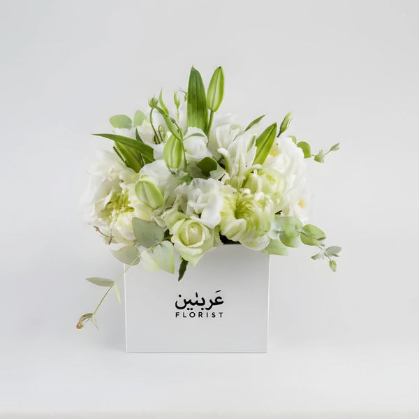 Floral arrangement in a box with 'Arabes Florist' branding on a light gray background
