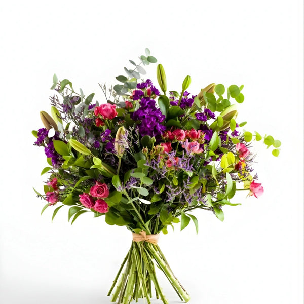 Bouquet of colorful flowers with green leaves on a white background