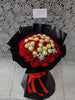 red roses and ferrero hand bouquet